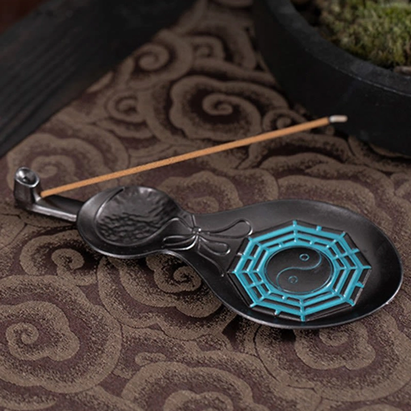 Handcrafted gourd incense burner with Yin Yang Bagua symbol and incense stick in meditation room setting