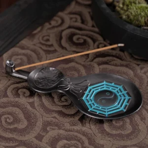 Gourd Yin Yang Bagua copper incense burner with lit incense stick on cloud-patterned meditation altar