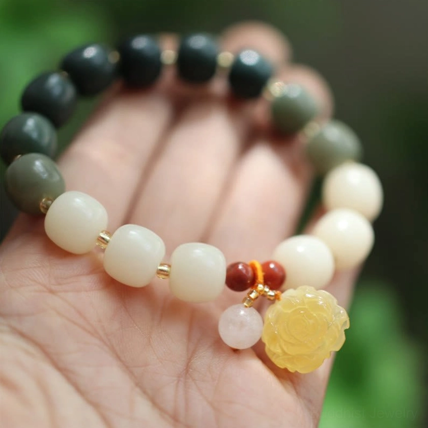 Right-side bead gradient display of handmade bodhi seed amber lotus bracelet with complete charm set
