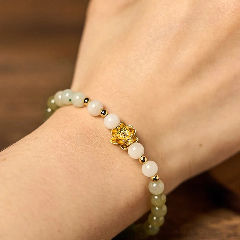 Front view of worn jade gradient lotus bracelet on wrist, showing clear color transition and shiny gold lotus pendant