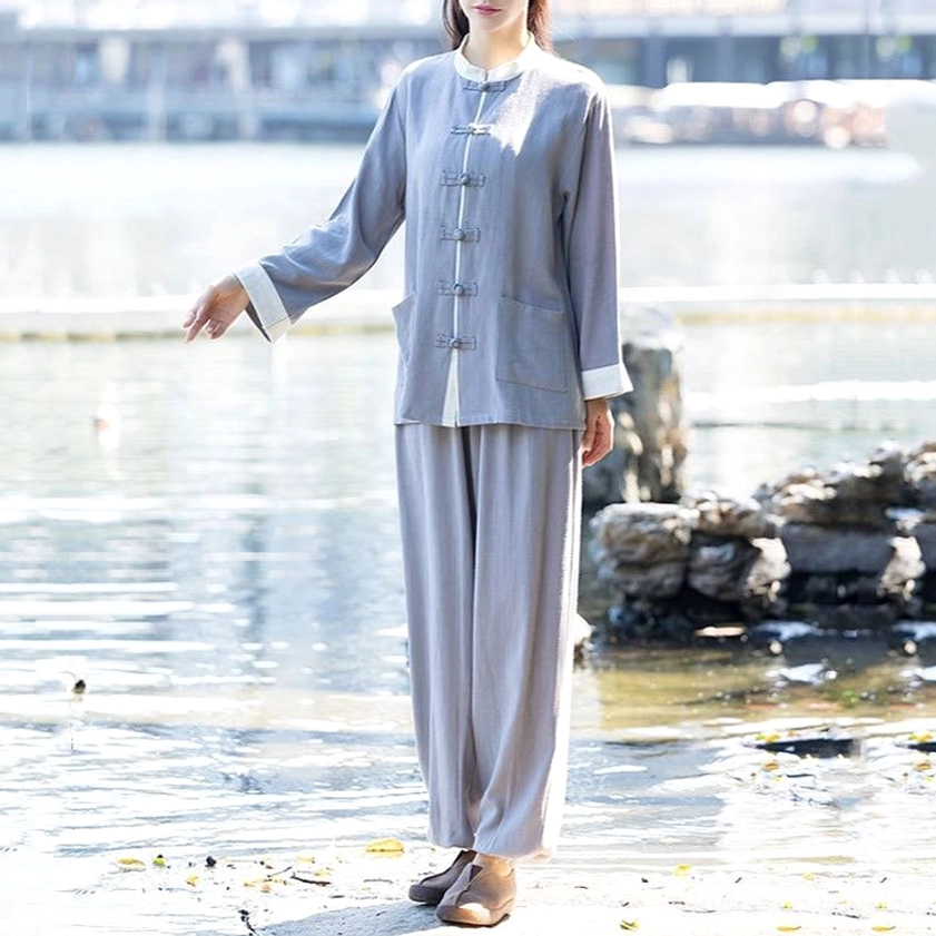 Gray two-piece zen meditation suit with relaxed tapered pants and patch pockets, front view at lakeside