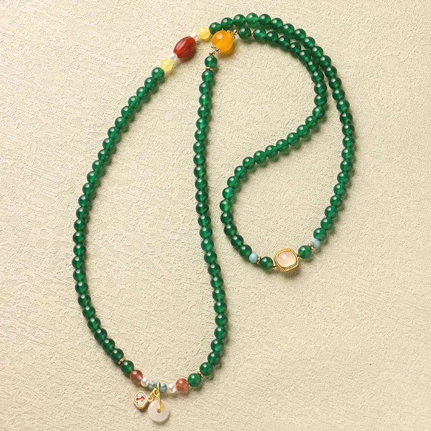 Long green agate mala necklace with peace buckle and minimalist gemstone accents in side view