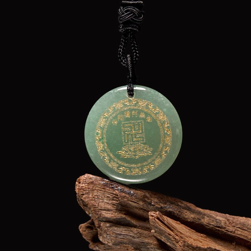 Green aventurine Buddhist pendant with gilded swastika symbol and braided black cord