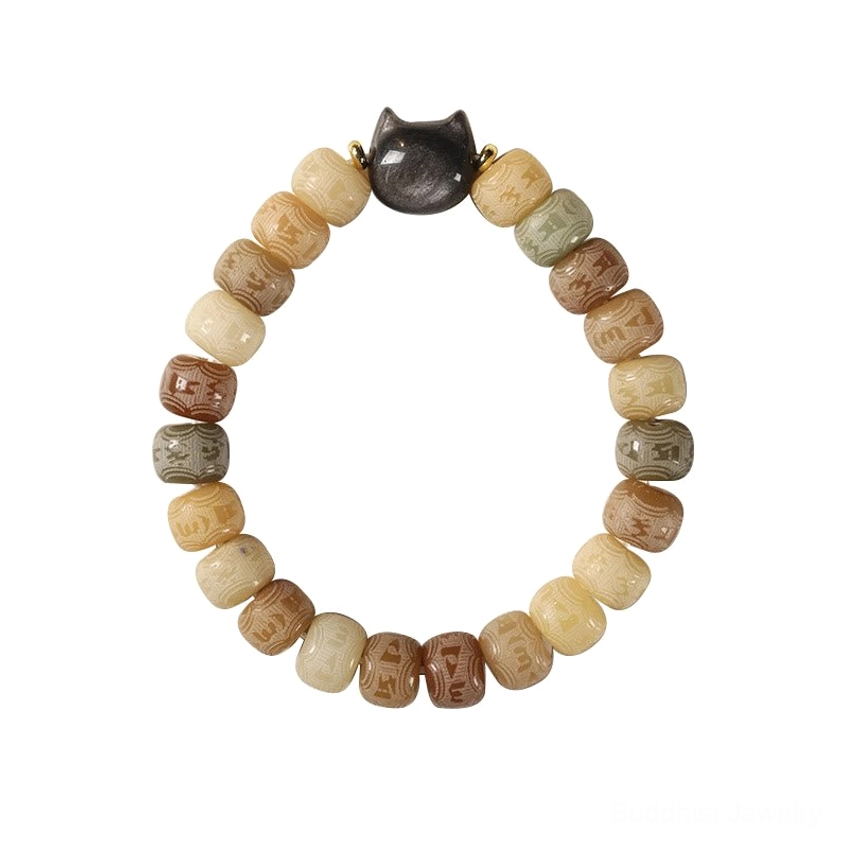 Green bodhi seed bracelet with black obsidian cat head, overhead view showing cool-toned beads and spiritual charm