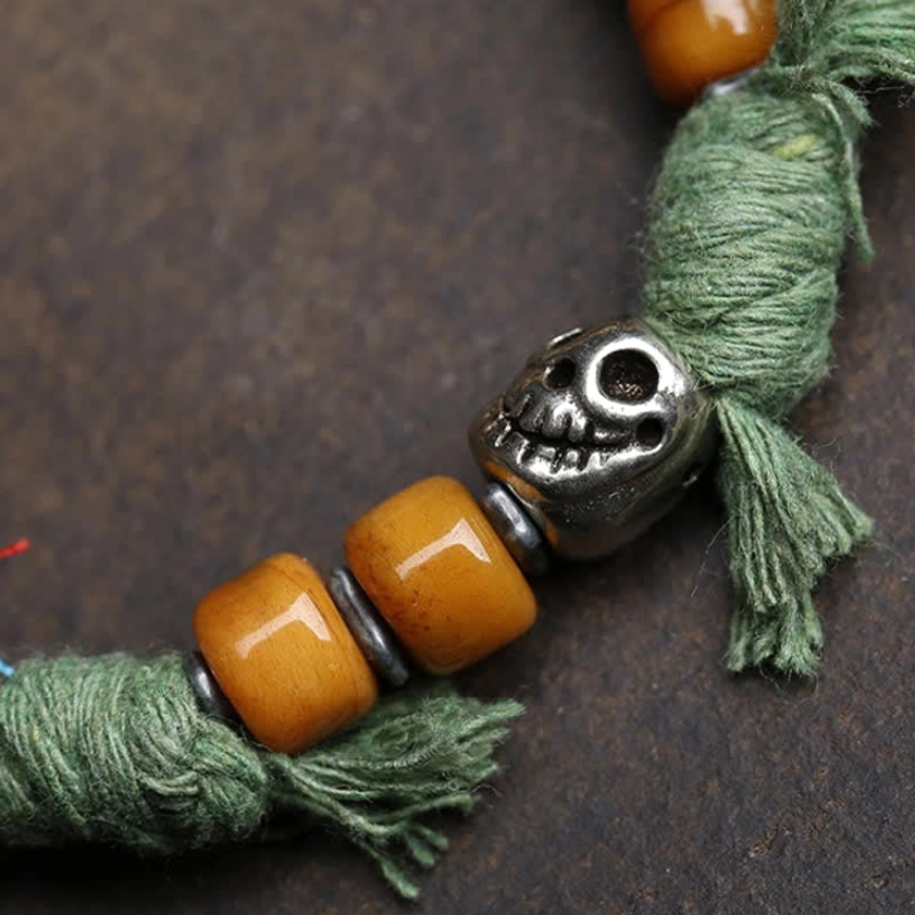 Green braided cord Amitabha Buddha bracelet with yellow agate beads and silver ornament detail