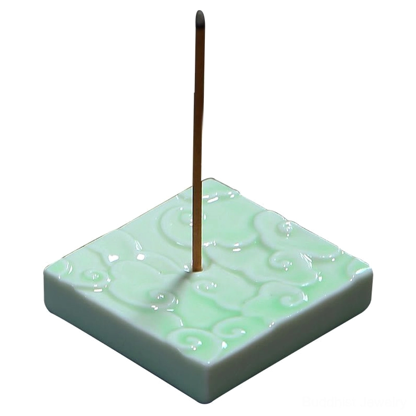 Front-facing close-up of celadon ceramic square cloud incense burner against white studio background, displaying glossy glaze finish and inserted burning incense