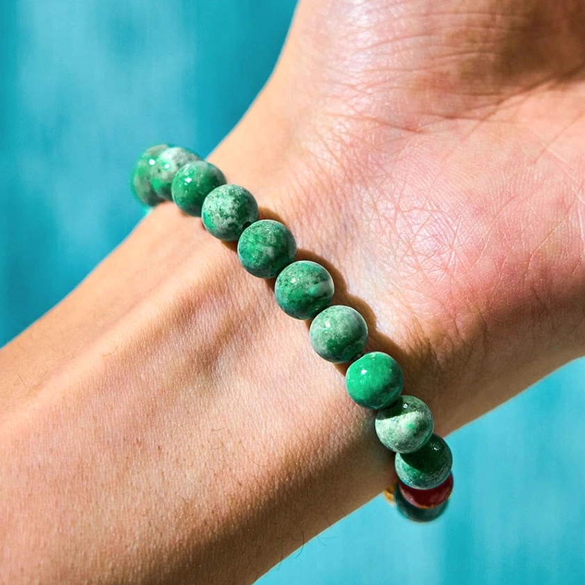 Minimalist green marbled jade beaded bracelet on hand showing texture and craftsmanship