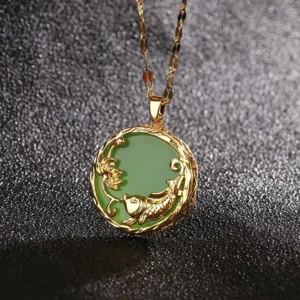 Green jade koi fish lotus necklace pendant close-up with gold embossed details on dark background