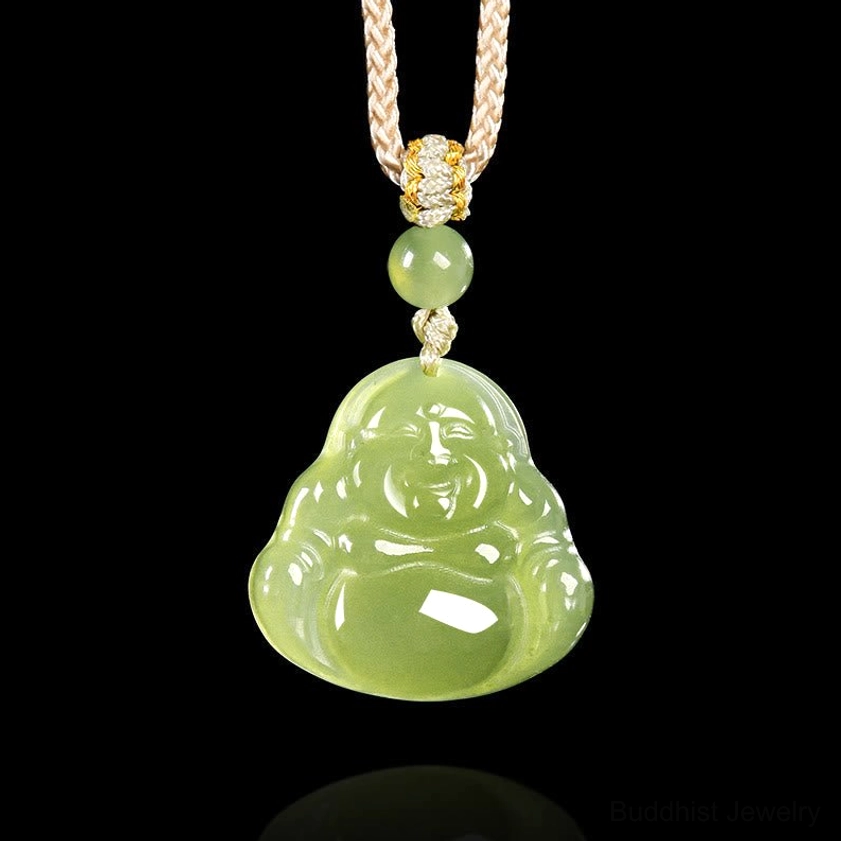 Green jade laughing Buddha pendant necklace front view on black background, showing polished light green jade with braided rope and gold-toned decorative knot