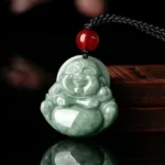 Natural green jade Laughing Buddha pendant necklace front three-quarter view with black braided cord and red accent bead