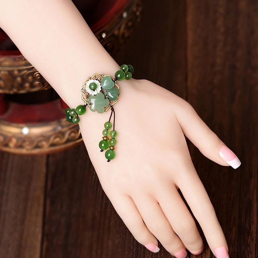 Green jade bracelet showing natural stone variations and authentic crystal characteristics, close-up detail