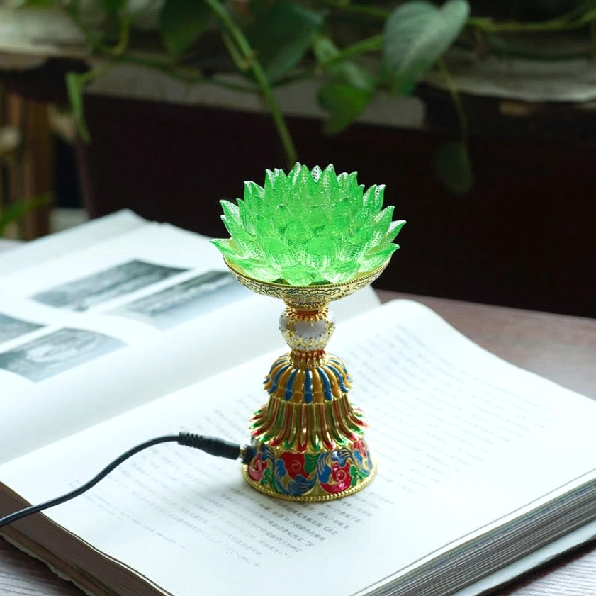 Green liuli glass lotus lamp representing growth rebirth and spiritual renewal