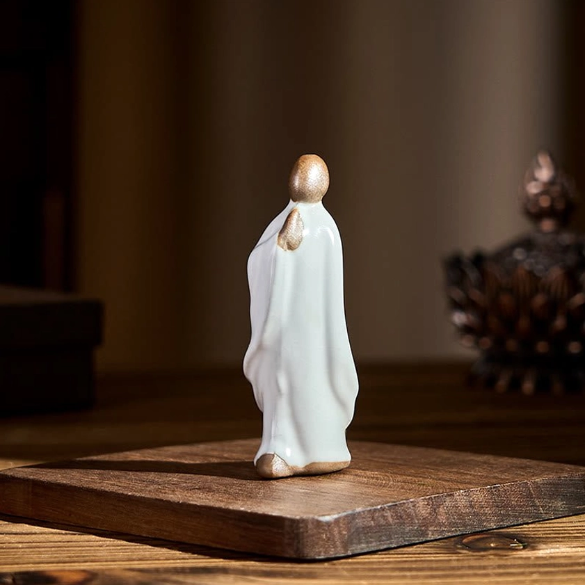Green ceramic meditation monk with serene expression spiritual home sanctuary