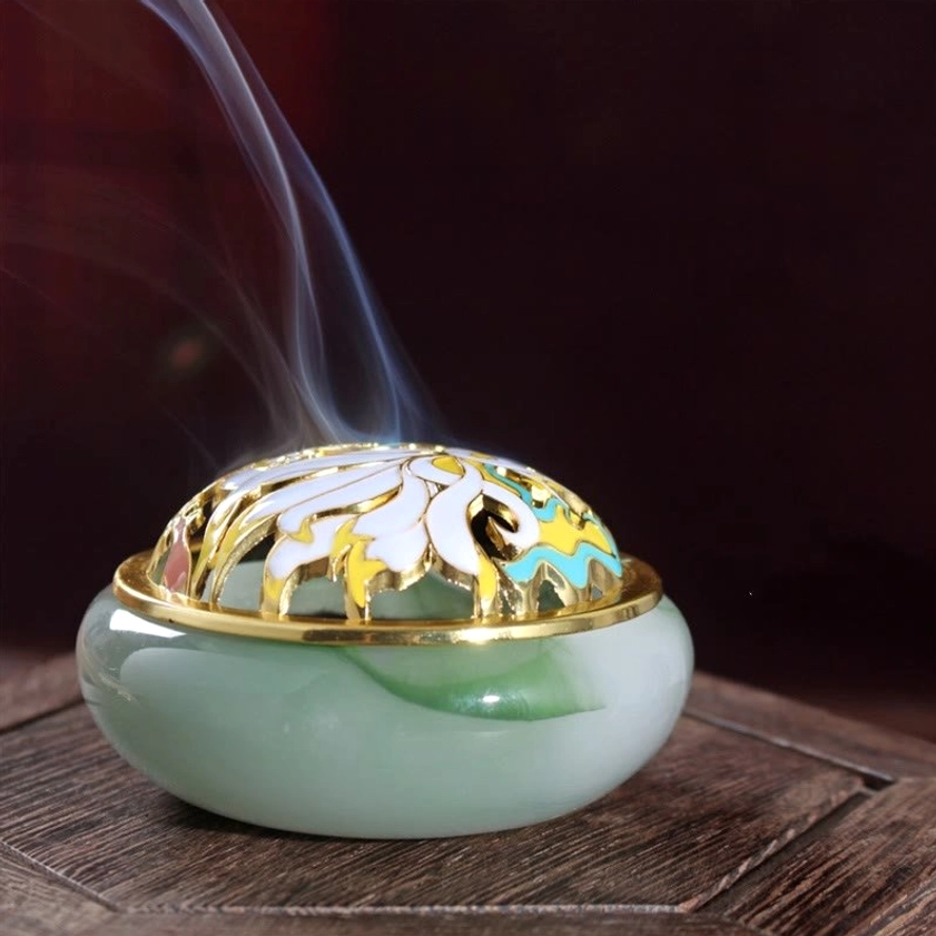 Jade green nine-tailed fox liuli crystal incense burner close-up front view with white veining, gold trim, multi-color cloisonne carved lid, and emitting aromatic smoke