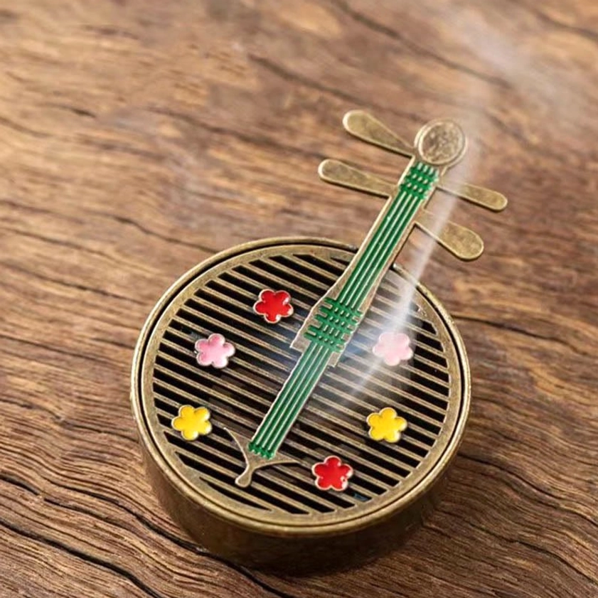 Green pipa Buddhist incense burner with colorful flower inlays and grid-style ventilation system