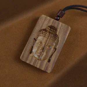 Handcrafted green sandalwood Buddha pendant necklace with natural wood grain, featuring carved Buddha face detail and brown rope cord - front overhead view