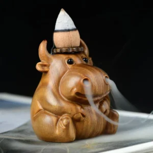 Green sandalwood calf backflow incense burner with smoke flowing from nose, handcrafted wood sculpture with natural grain texture