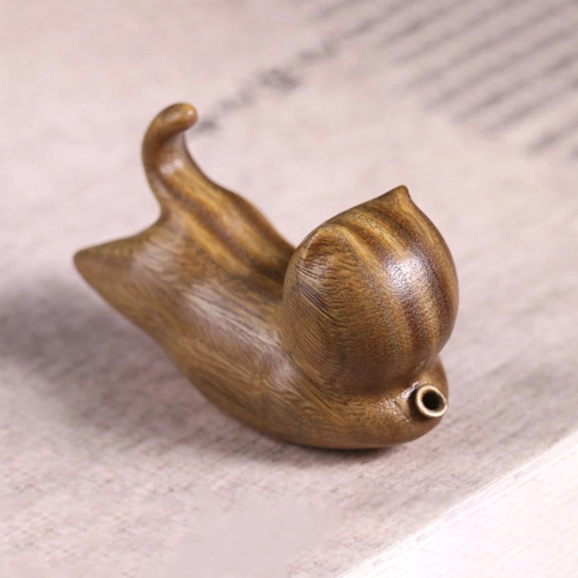 Green sandalwood cat-shaped incense holder bottom right angle, showcasing natural wood texture, metal incense socket, and curled tail design
