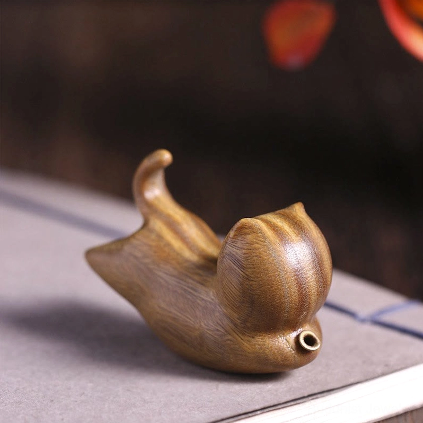 Natural green sandalwood cat incense holder right side perspective, showing metal incense port and natural wood grain on decorative background