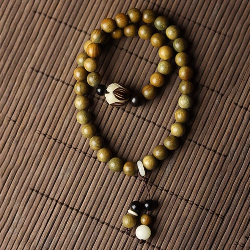 Green sandalwood Bodhi seed lotus double wrap bracelet lifestyle shot showing spiritual wellness and meditation practice use