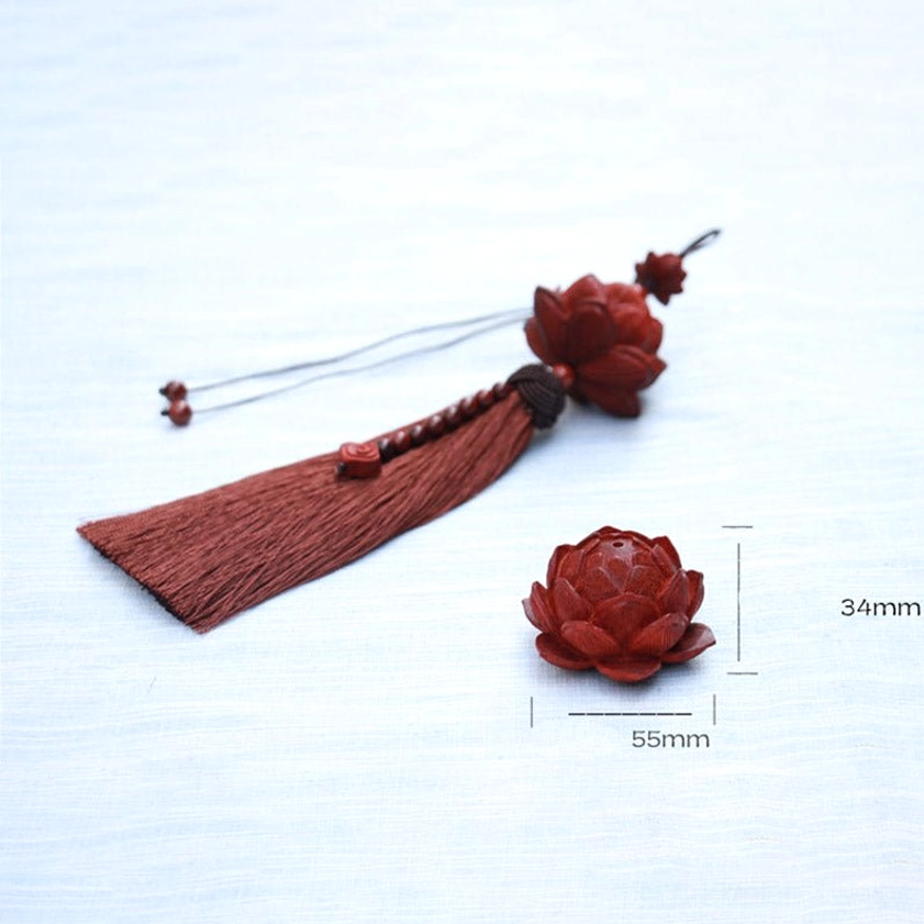 Handmade green sandalwood lotus tassel with beaded accents displayed as home decor