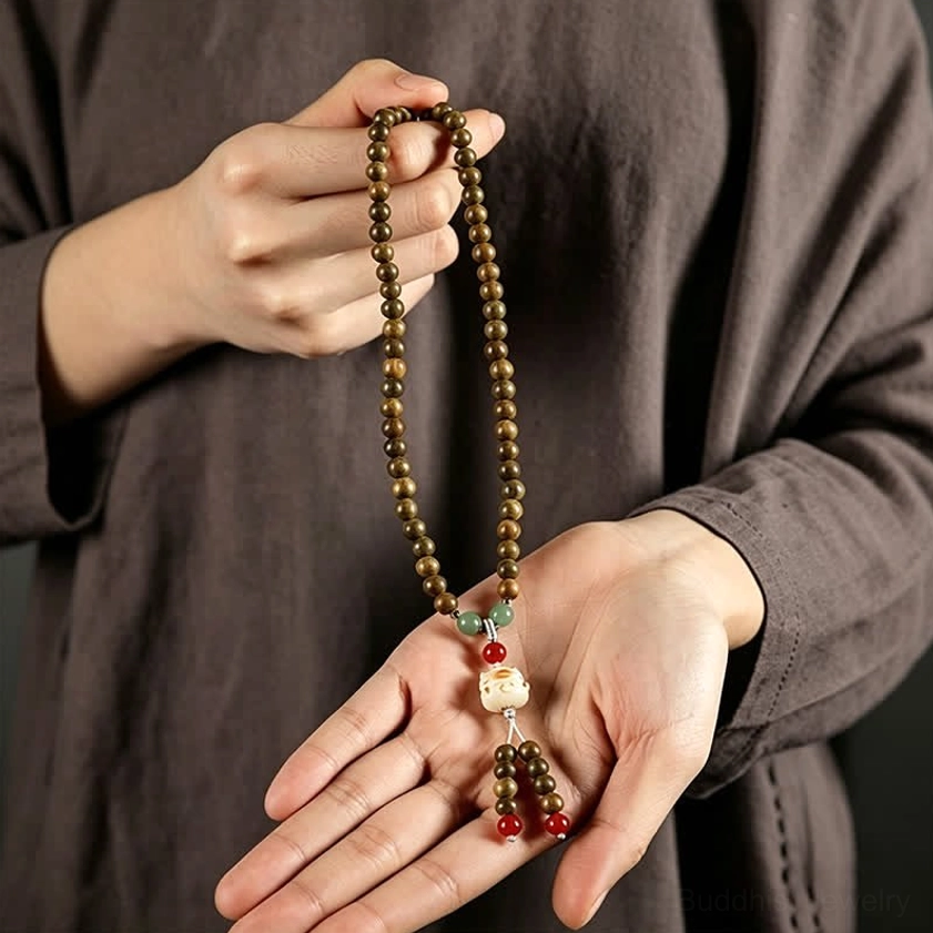 Green sandalwood mala bracelet single bead close-up highlighting natural wood grain and color variation