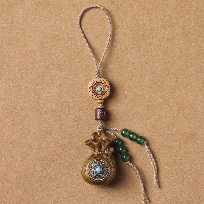 Green sandalwood Om Mani Padme Hum phone hanging decoration with linen rope and green bead tassel on kraft paper