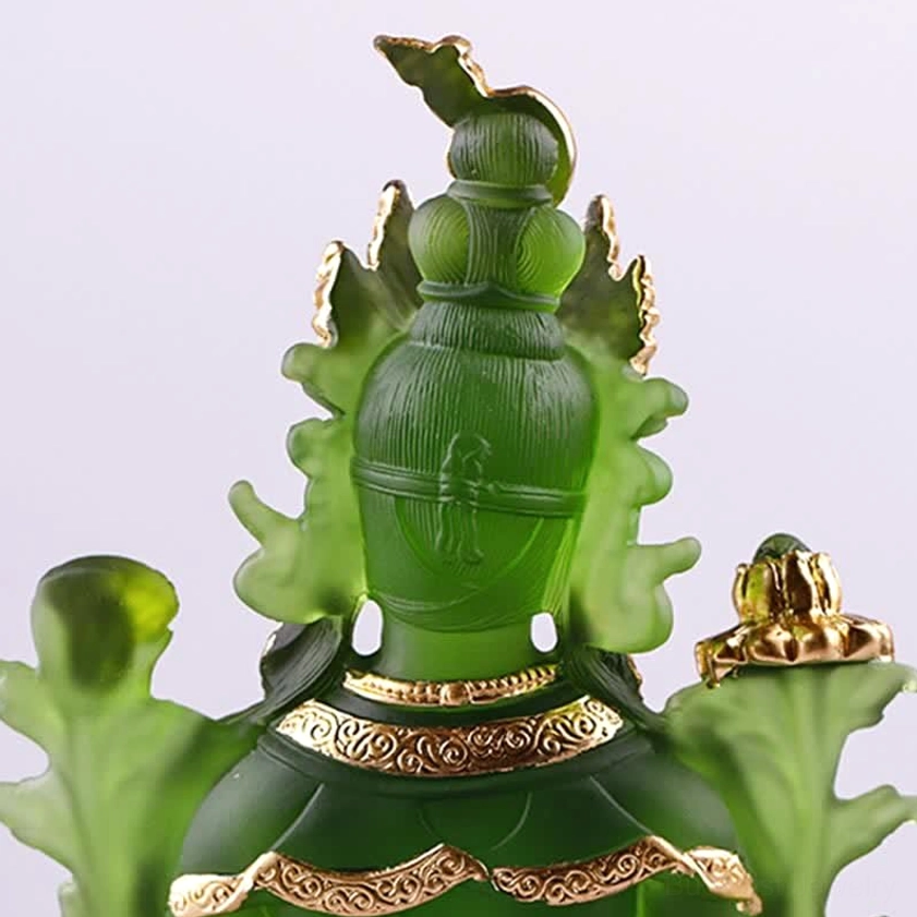 Green Tara Buddha head front close-up with translucent emerald green and elaborate carved gold crown ornaments and jewelry