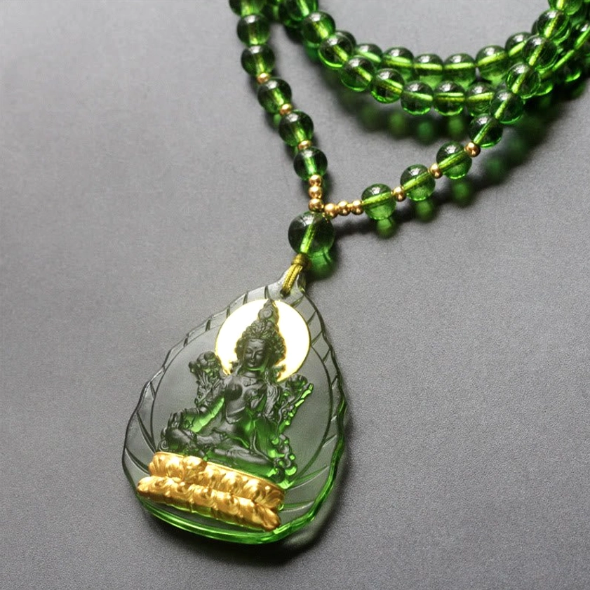 Green Tara Buddha pendant necklace low angle view with double-strand beaded chain and gold-plated Buddha base