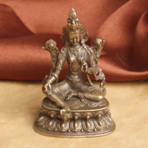 Green Tara Buddha statue frontal view on red satin - handcrafted copper compassion sculpture with lotus pedestal