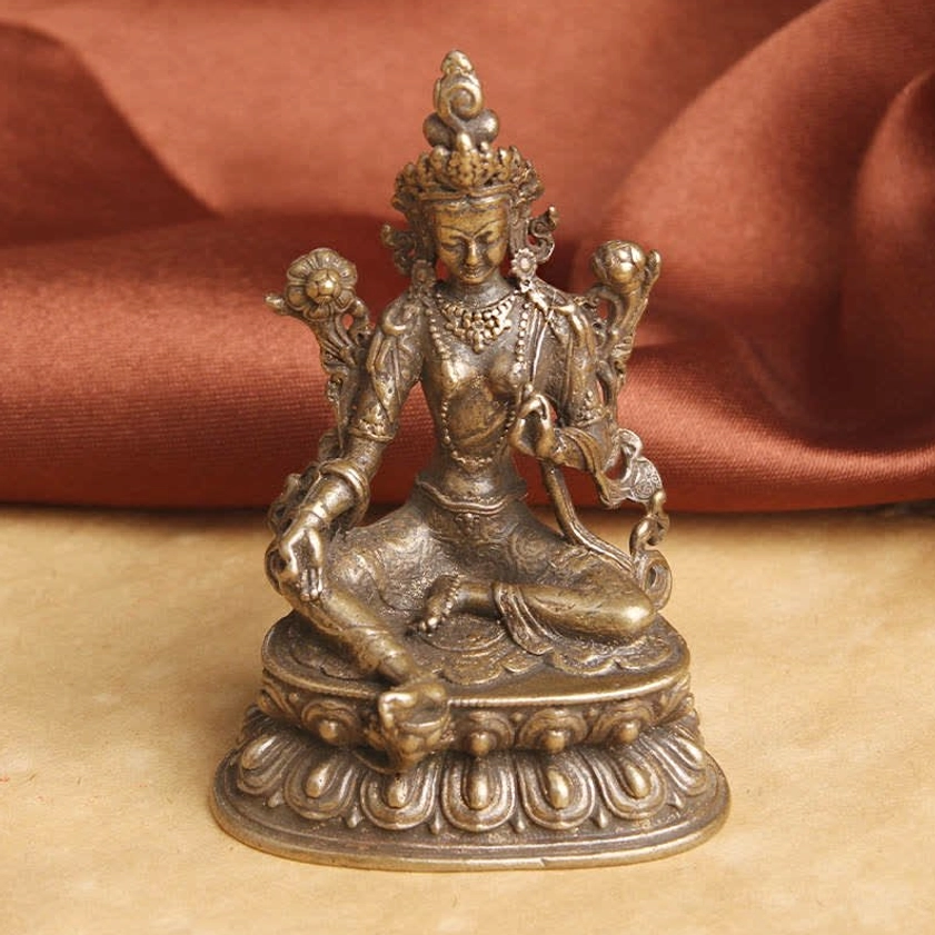 Green Tara Buddha statue frontal perspective displaying hand gestures and ornate decoration with copper finish