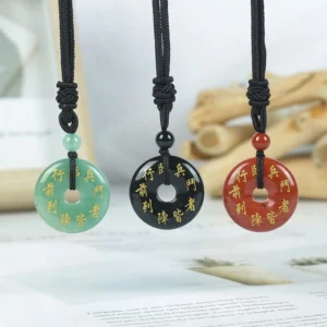 Green Tara mantra crystal pendants collection showing three natural stone variants with golden Sanskrit engraving and black braided cord