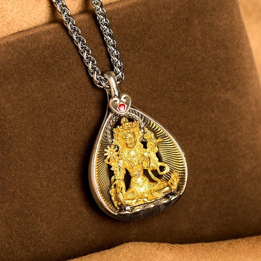 Green Tara copper Buddhist pendant necklace close-up detail showing engraved frame and red gem heart clasp