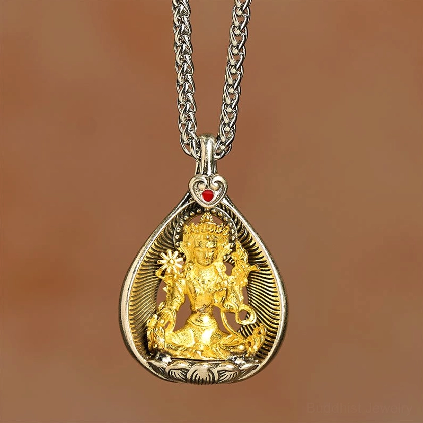 Green Tara Buddhist necklace pendant laying flat showing silver wheat chain and gilded deity statue