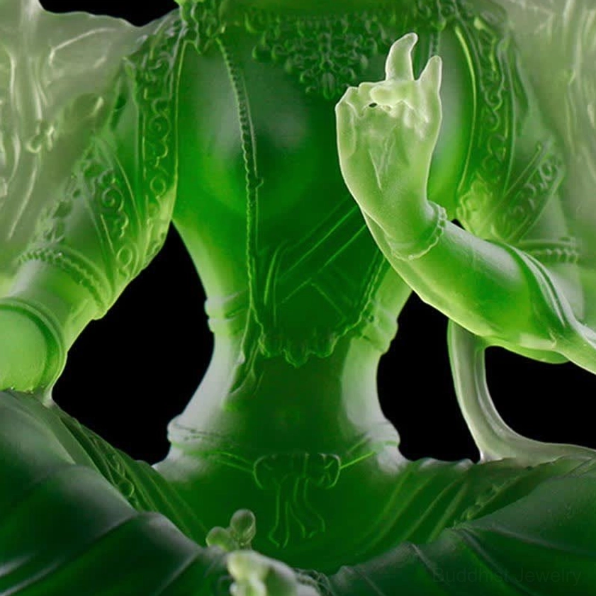 Green Tara Buddha statue torso and hand details close-up showing carved body texture and traditional Buddhist mudra gesture