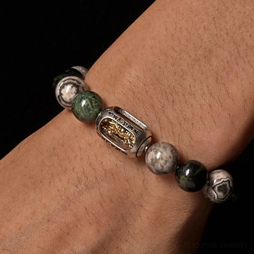 Grey Jasper Buddhist bracelet worn on wrist showing natural stone texture and spiritual charm design