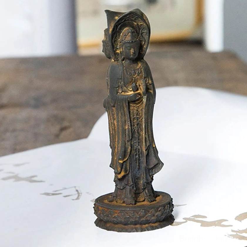 Avalokitesvara resin statue front view on paper with weathered brown cast finish