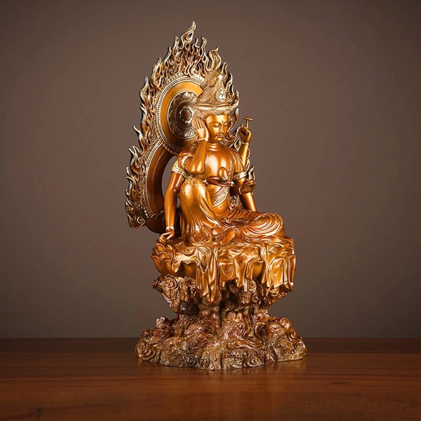 Guanyin Avalokiteshvara Buddhist statue frontal eye-level view showing ornate hand mudras and flame backplate