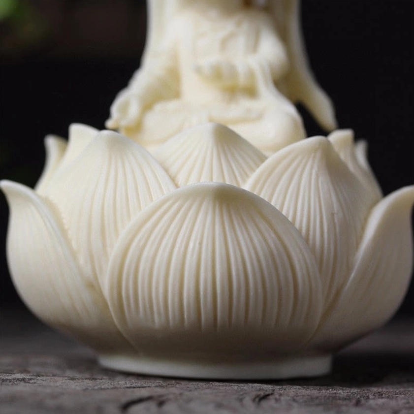 Low-angle front view of Guanyin Buddha on ornate lotus flower throne with detailed petal carving and serene meditation posture
