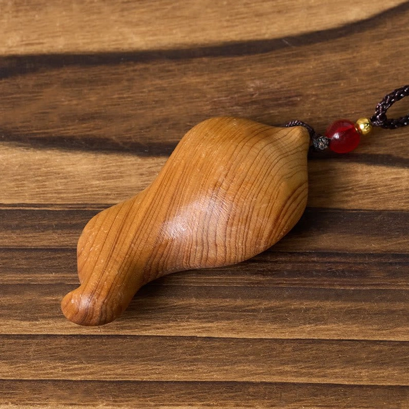 Buddhist Guanyin wood pendant necklace back view with decorative black cord and red gold beads