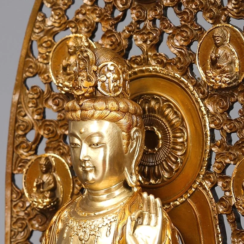 Close-up of Guanyin head and upper backplate - serene facial expression with carved cloud patterns and buddha medallions