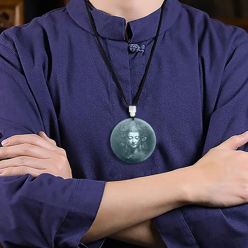 Woman wearing Guanyin jade necklace with black cord and traditional clothing