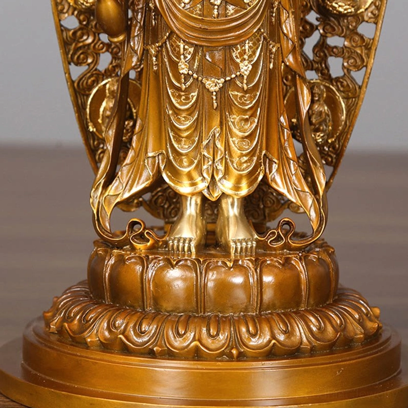 Guanyin Avalokitesvara brass statue detail - hand-carved ornamental robes with decorative engravings and polished finish
