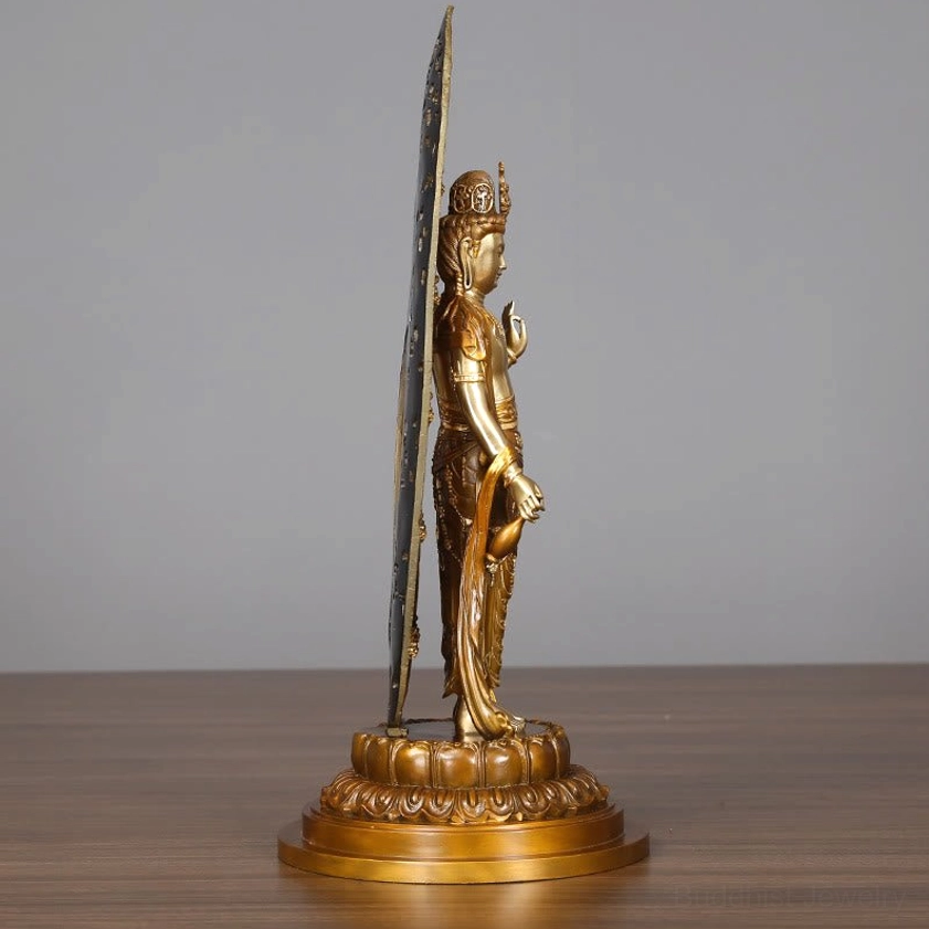 Guanyin brass statue extreme left angle - slim profile showing vertical flame backplate with celestial carvings