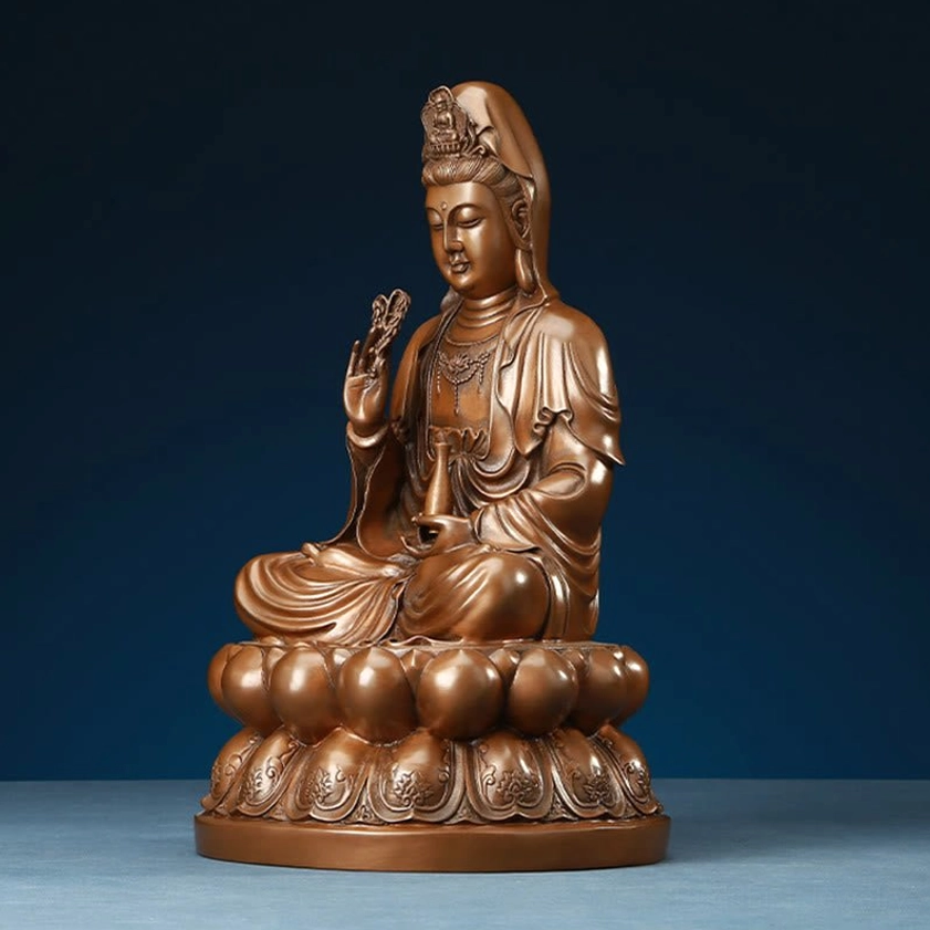 Avalokitesvara Guanyin copper statue positioned on wooden table surface with neutral background for home decor display