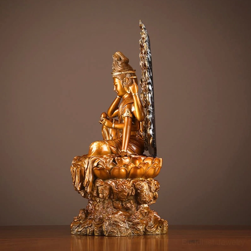 Four-armed Guanyin statue rear-side view with ornate flame backplate and lotus rock base, antique bronze tone