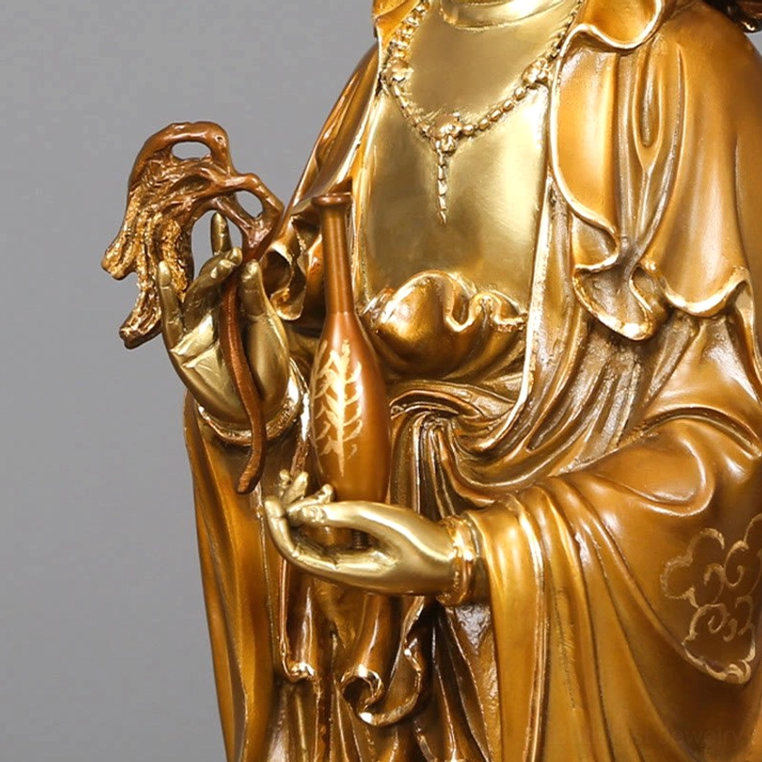 Guanyin brass statue upper body close-up showing carved robes and polished bronze finish