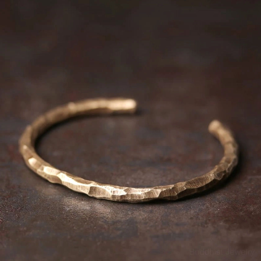 Handcrafted hammered brass cuff bracelet, showcasing artisanal detail and natural eco-friendly material for chakra alignment and wealth attraction