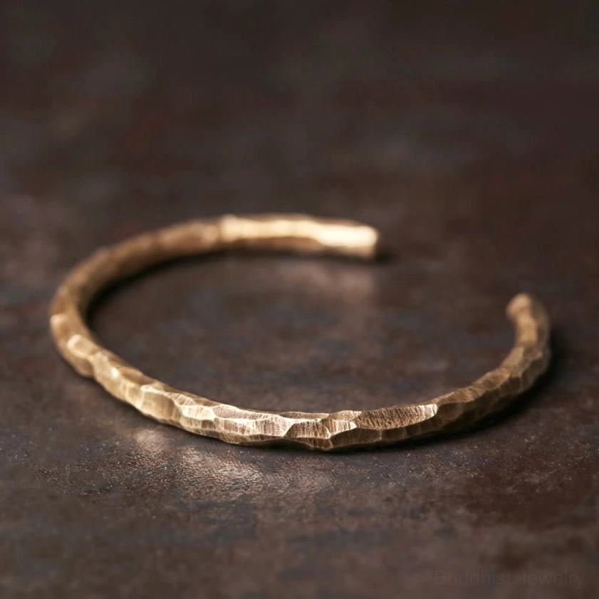 Hammered brass cuff bracelet full circle overhead view, displaying complete open-ended bangle design with consistent textured finish