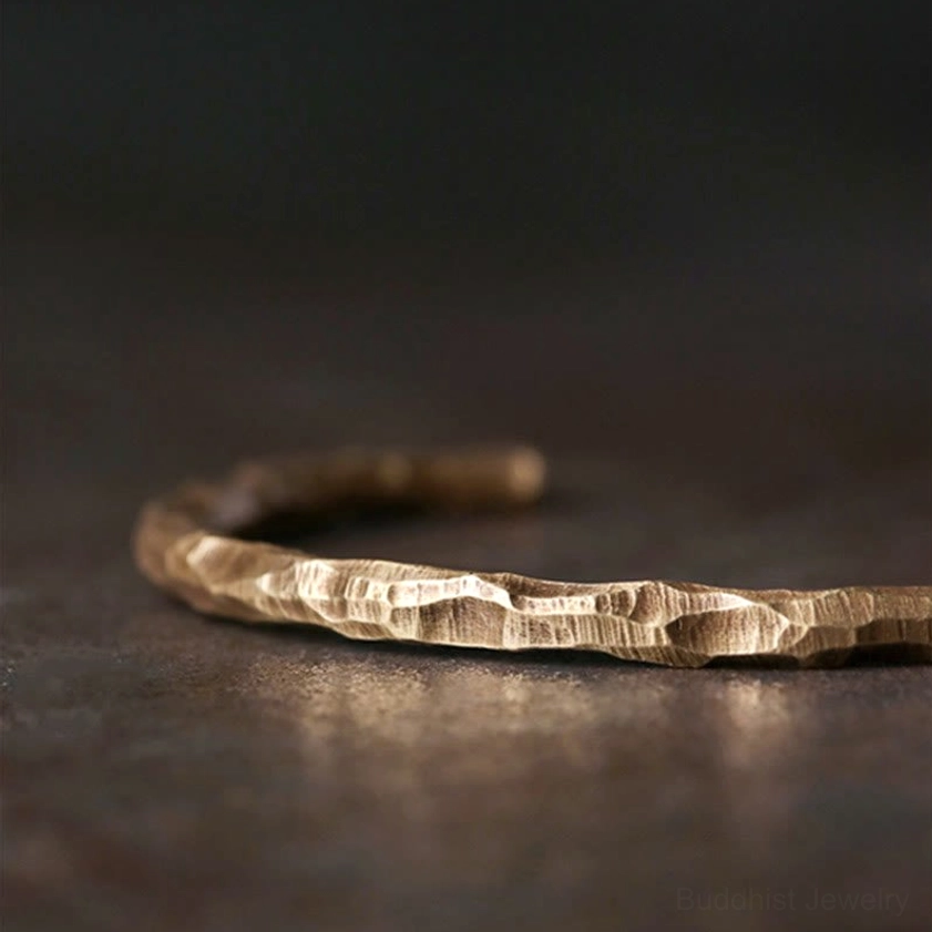 Hammered brass cuff bracelet side profile, showcasing detailed bumped texture and open cuff design for spiritual connection